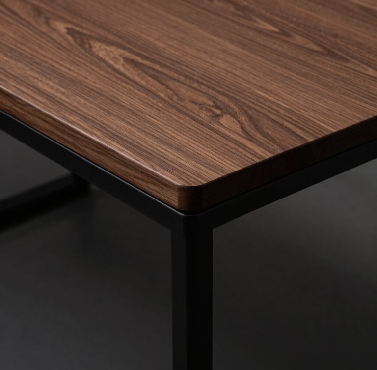 Wide-angle overhead shot of a clean, minimalist walnut desk with zero visible wires, sharp 90-degree cable bends routed along matte black steel legs, moody side-lighting.