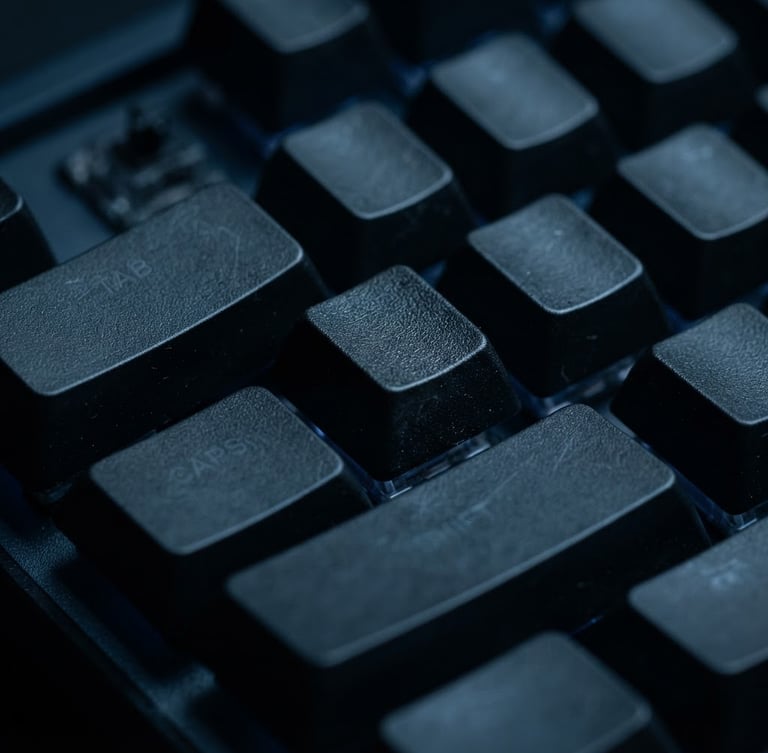 Macro shot of mechanical keyboard keys in low-key cool-toned studio lighting, deep midnight blue shadows, sharp focus on keycaps