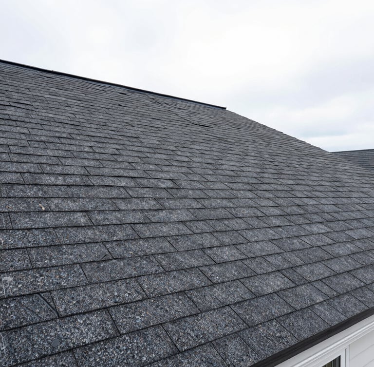 Sharp wide-angle construction photography of a newly installed asphalt shingle roof on a Syracuse home, bright overcast daylight, realistic saturated colors