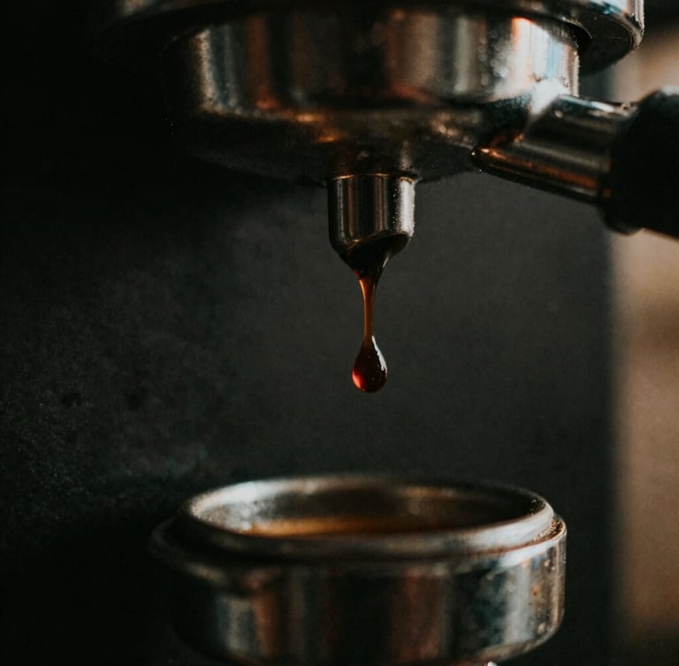 Macro close-up of a single dark espresso drop falling from a bottomless portafilter, golden-hour side lighting, moody dark background, 35mm film style.