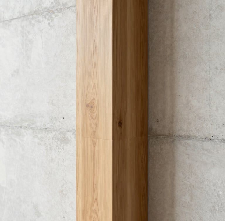 Architectural detail of a seamless corner where warm rift-sawn oak meets a polished concrete wall, bright indirect natural light, minimalist luxury, portrait aspect