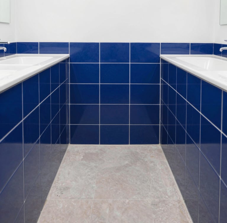 Straight-on architectural photograph of a perfectly aligned modern bathroom dado under bright natural daylight, crisp royal blue tile joints, professional masonry work