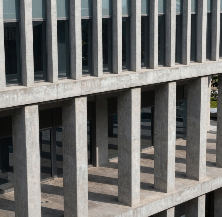 High-angle structured architectural view of modern concrete and steel columns in a clean Mumbai corporate headquarters, crisp daylight casting geometric shadows, no people.