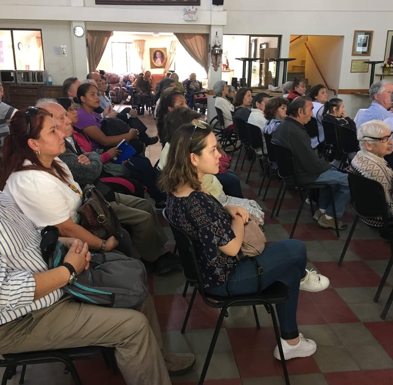 a group of people sitting in chairs in a room