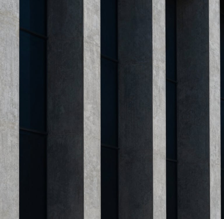 Macro architectural crop of concrete columns and glass facades, sharp geometric shadows, high-contrast minimalist photography, deep navy tones