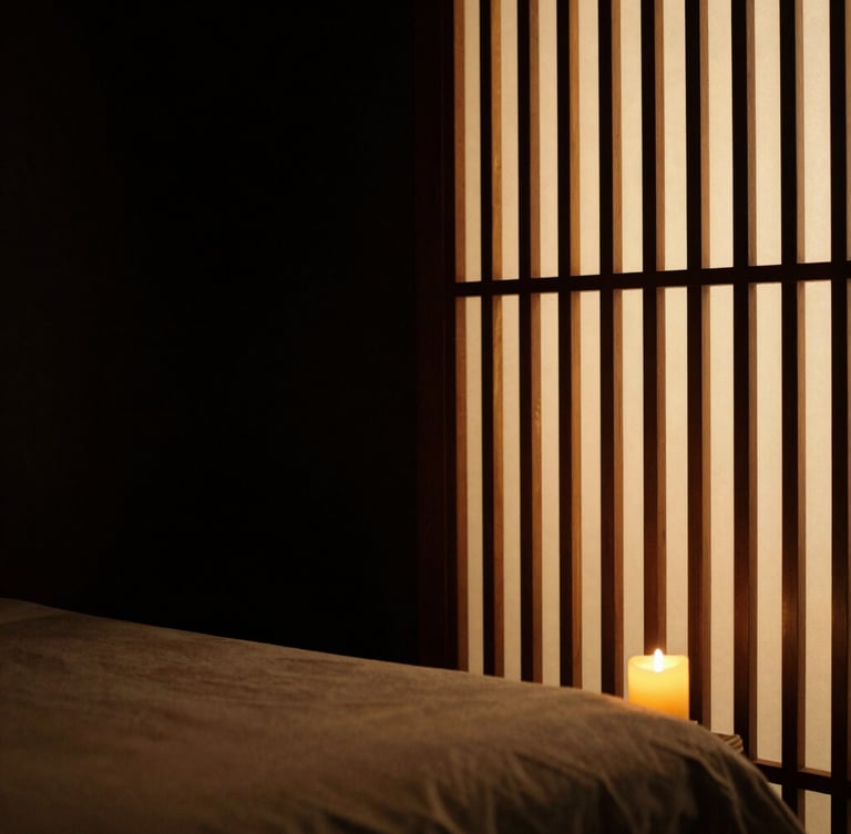 Chiaroscuro shot of a minimalist luxury massage room, warm light filtering through a wooden screen, absolute peace
