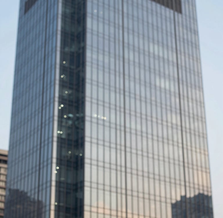 A sophisticated close-up of a modern skyscraper's glass exterior reflecting a clear sky, symbolizing growth and high-end commercial property in Haryana. Style is clean and minimalist with professional architectural photography lighting, using subtle blue tones.
