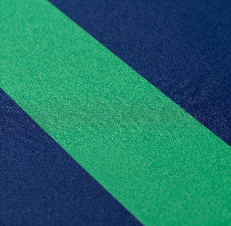 Close-up of high-precision sublimation printing on athletic fabric, vibrant colors merging under crisp studio lighting, textile texture visible, 35mm
