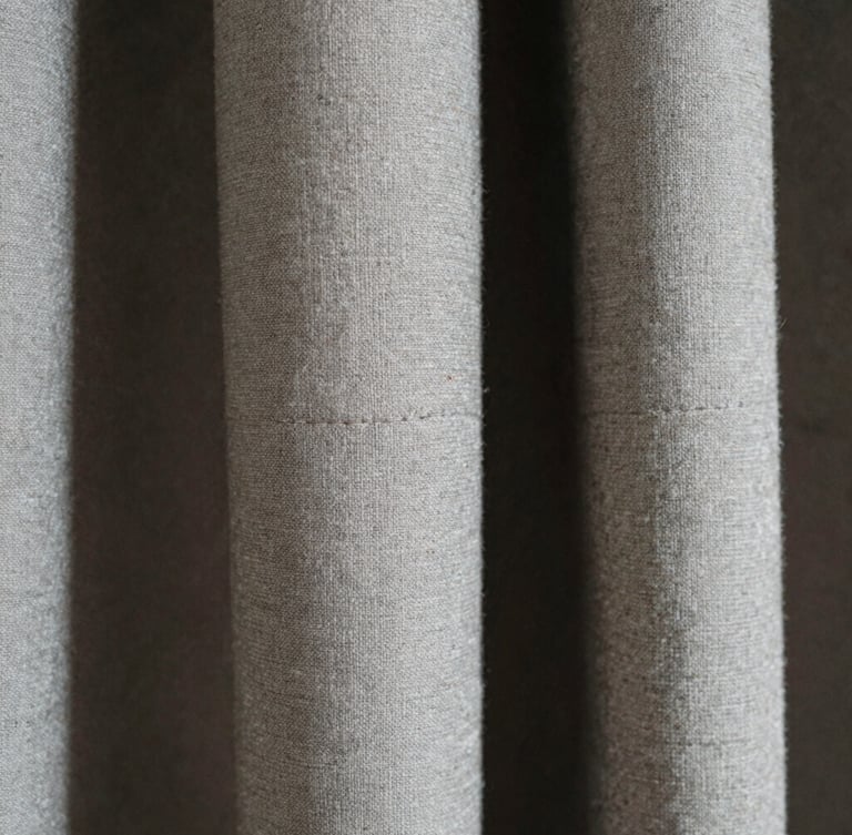 Extreme close-up macro photography, high-contrast natural light, the detailed weave of heavyweight Japanese cotton, raw textured seams, desaturated tones, 35mm