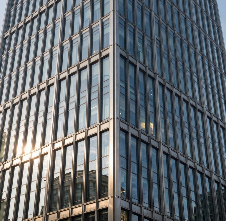 Crisp morning light reflecting off a geometric steel-and-glass facade of a modern corporate skyscraper, sharp architectural lines