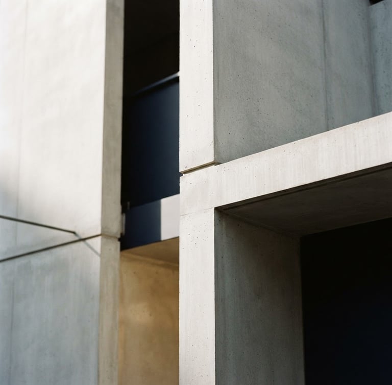 Close-up of elegant minimalist architectural concrete lines with deep shadows, soft natural daylight, warm champagne accents, 35mm photography
