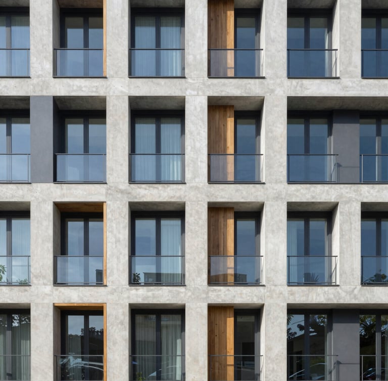 Straight-on architectural photograph of a modern concrete and glass apartment building exterior under bright morning daylight, sharp focus, 35mm