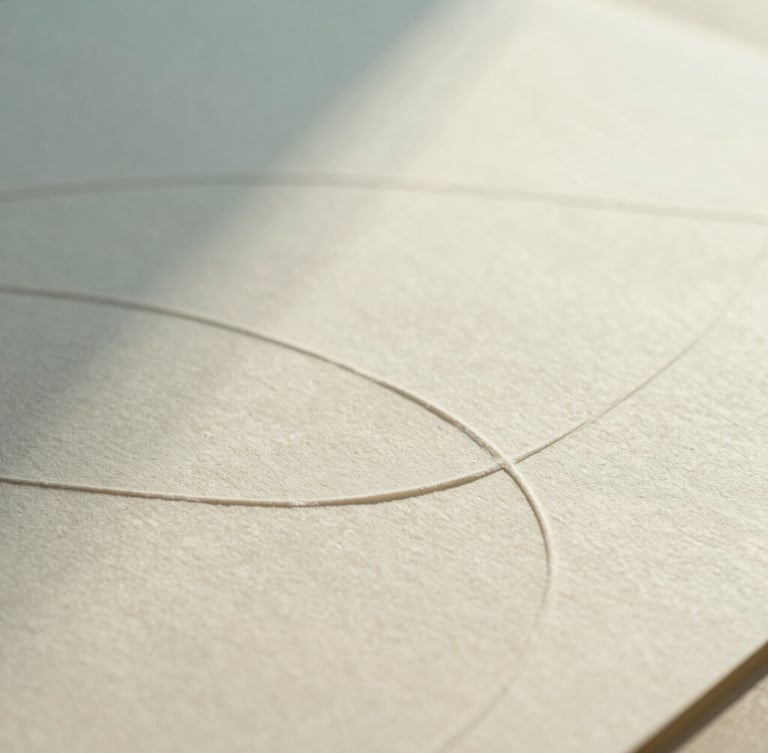 Close-up of tactile design materials on a warm cream surface, soft textured paper with embossed curved lines, diffused natural daylight, cool cyan shadows, shallow depth of field, minimalist abstract photography.