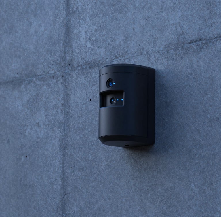 Close-up of a matte black security sensor seamlessly embedded in a raw concrete wall of a luxury villa, twilight blue hour lighting, sharp focus, 35mm.