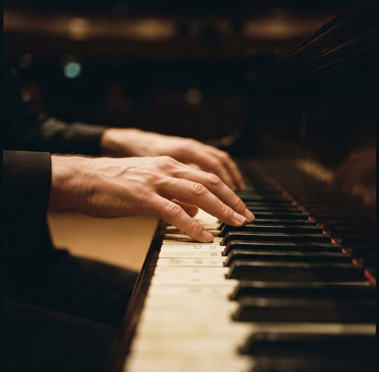 Close-up of a pianist's hands on physical piano keys, dramatic side-lighting, deep charcoal and warm amber tones, shallow depth of field.