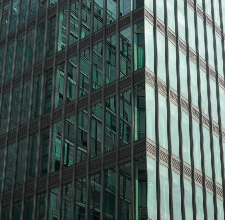 Sharp geometric crop of modern glass office facade in Dhaka, bright natural daylight, high-contrast structural green reflections, 35mm