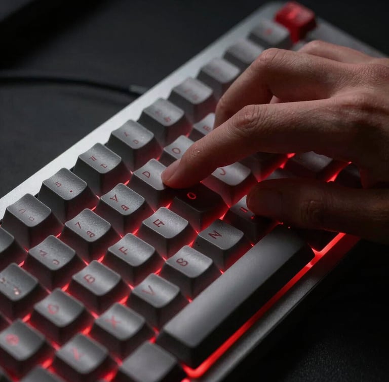 Macro close-up of hands on a mechanical keyboard, high-contrast studio lighting, sharp red backlighting glow, clean minimalist composition, 35mm