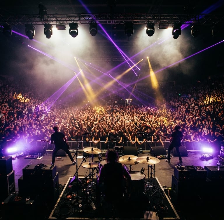 Dynamic low-angle shot of a massive concert crowd from behind the stage, electric purple laser beams cutting through haze, vibrant gold spotlights, high-contrast, 35mm film grain