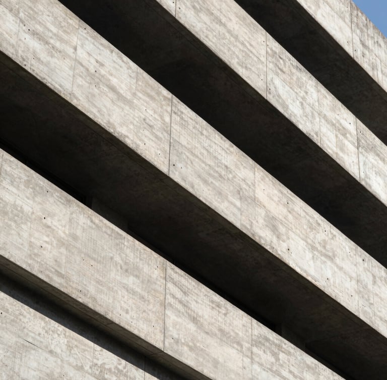 High-contrast architectural details of a brutalist concrete building, sharp diagonal shadows, dramatic natural side-lighting, clean lines, minimalist framing.