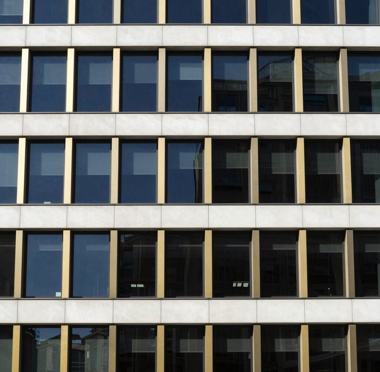 High-contrast architectural detail of a modern office building facade, clean lines, deep navy and gold accents, bright natural daylight, minimalist composition, 35mm