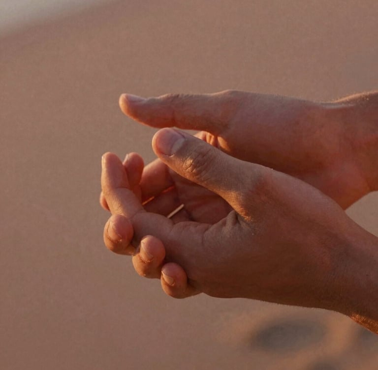 Close-up of two hands gently holding each other, fingers intertwined, warm golden hour sunlight illuminating the skin, shallow depth of field, cinematic 35mm film.
