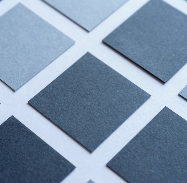 Close-up macro shot of physical design assets, textured paper mockups, clean geometric layouts, crisp studio lighting with cool blue undertones