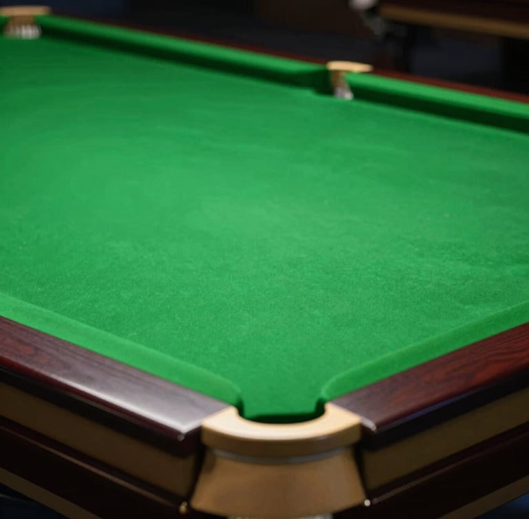 Dramatic close-up of a premium snooker table, rich forest green felt, polished brass pocket corners under moody overhead lighting, shallow depth of field, 35mm