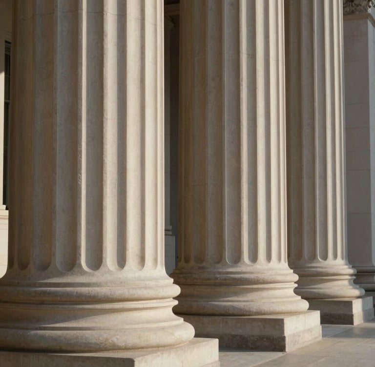 Architectural close-up of classical stone columns, soft natural side light, deep shadows, elegant sovereign legal aesthetic.