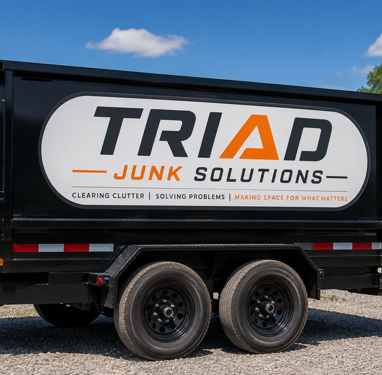 A black Triad Junk Solutions trailer for professional junk removal and hauling services.