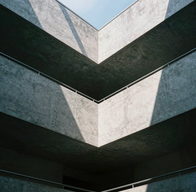 Low angle shot of a modern concrete atrium with clean geometric skylights casting sharp shadows, cool grey tones, 35mm lens