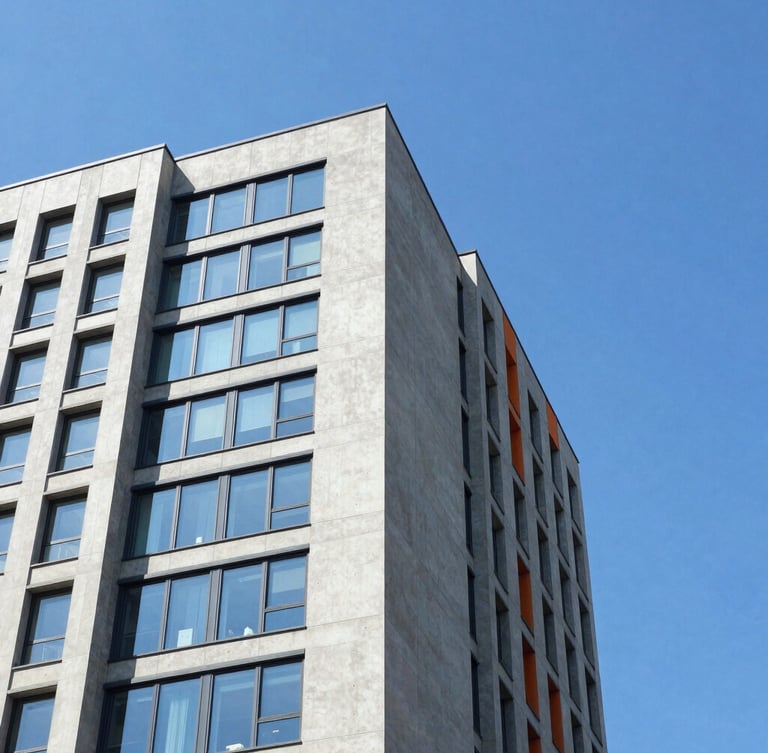 Low-angle architectural crop of a concrete and glass skyscraper corner slicing into a bright blue sky, sharp shadows, high-key natural daylight.