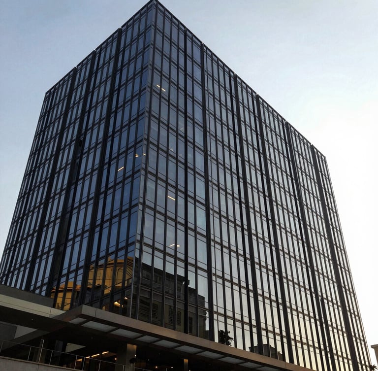 Wide-angle editorial photograph of a modern glass office building in Nairobi, bright natural morning light, architectural lines, rich navy tones, 35mm