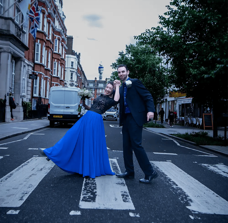 wedding couple walking on a pedestrian crossing