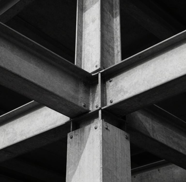 Symmetrical eye-level architectural detail of structural steel and concrete joints, sharp directional light, deep shadows, high-contrast black and white style.