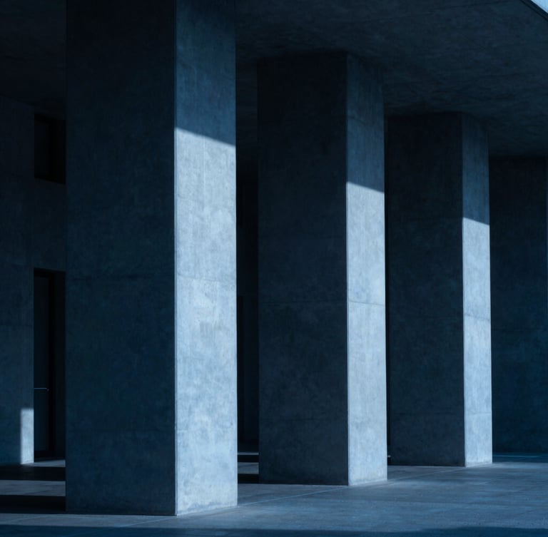 Moody architectural photography of clean geometric concrete columns casting sharp shadows, cool blue neon light accent, 35mm lens
