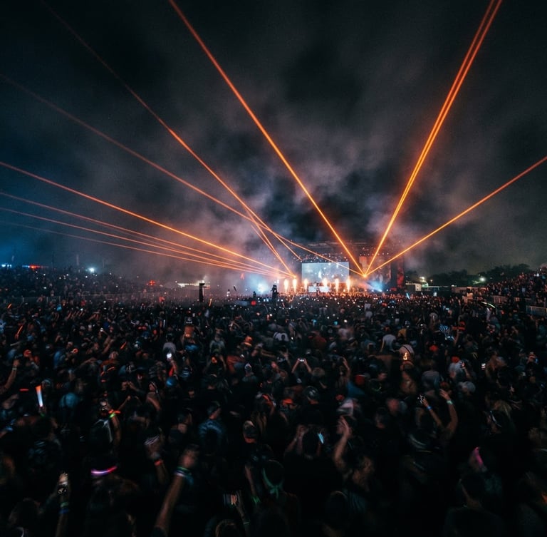 Dramatic long-exposure event photography showing sharp orange laser beams cutting through dark haze over a massive crowd, 35mm lens, wide environmental framing