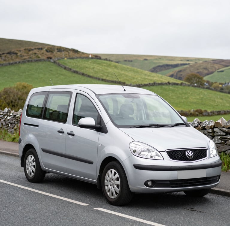 A clean modern silver taxi vehicle parked on a quiet street in Blackwood South Wales, bright overcast daylight, rolling green valley hills in the background, 35mm lens