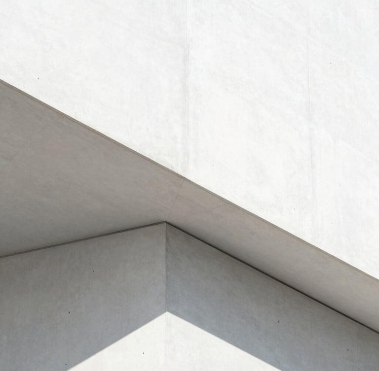 A sharp geometric concrete structure shot in bright high-key daylight, clean white and silver tones with razor-sharp shadows, minimalist architectural photography, 35mm lens
