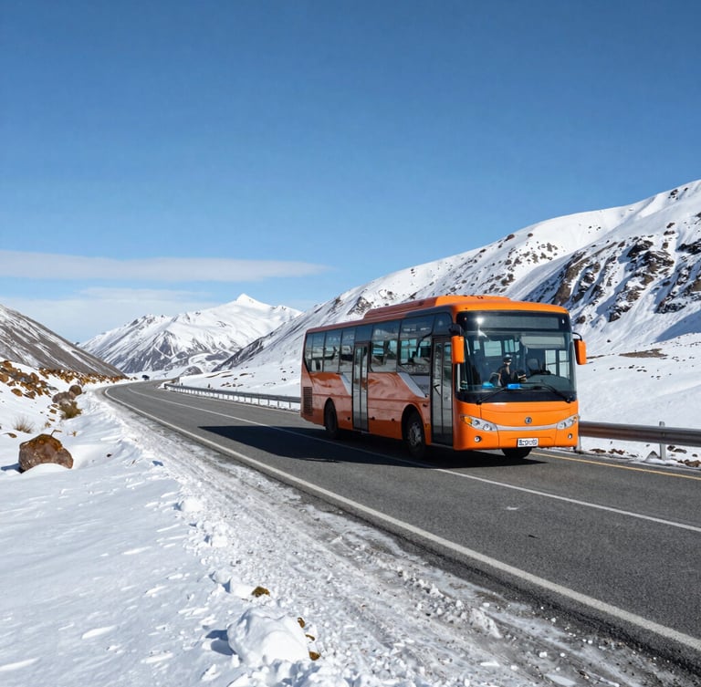 A modern long-distance bus driving safely on a winding Patagonian mountain highway, snow-covered roadside, clear daytime visibility under crisp alpine sky.