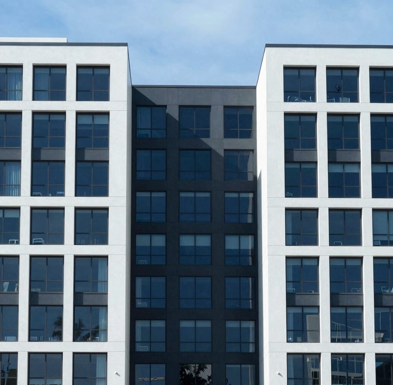 Symmetrical architectural crop of a modern South Florida commercial building facade, clean structural lines, bright daylight, cool blue and charcoal undertones
