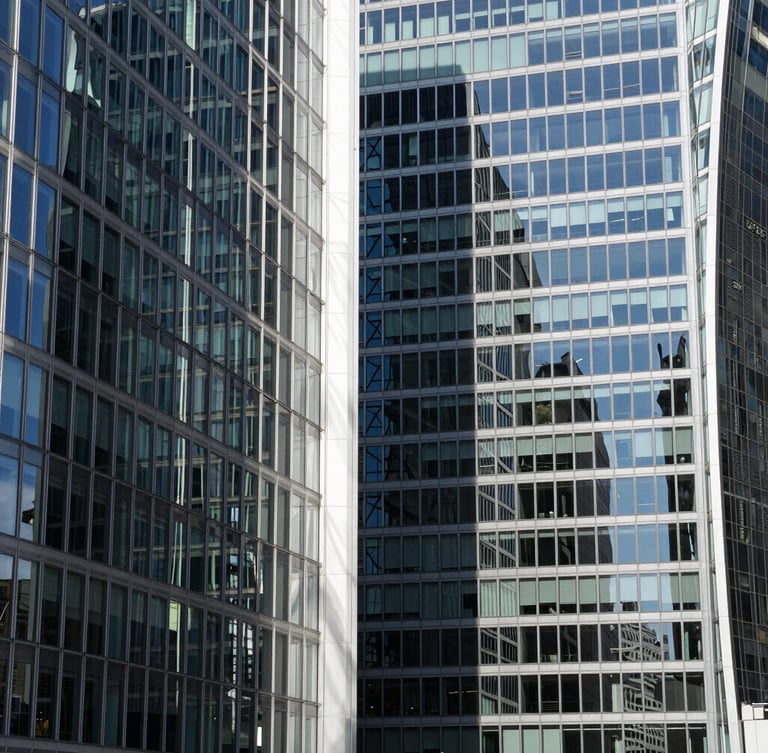 Abstract architectural lines of glass and steel skyscraper in London, sharp high-contrast shadows, bright daylight, clean editorial