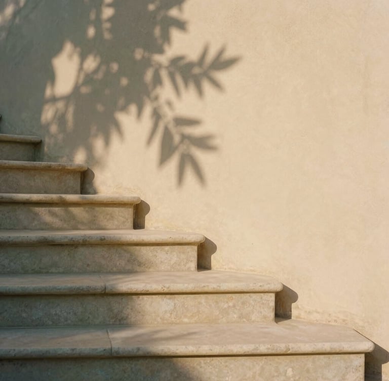 A minimalist stone staircase with exactly three steps, warm stucco wall background, soft olive leaf shadows, warm afternoon sunlight, architectural detail, 35mm