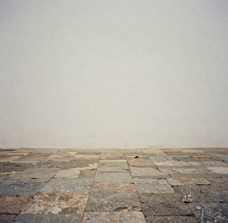 Minimalist fine art photography of a quiet stone courtyard in Brazil, soft diffused overcast light, desaturated earth tones, quiet contemplative composition, 35mm film