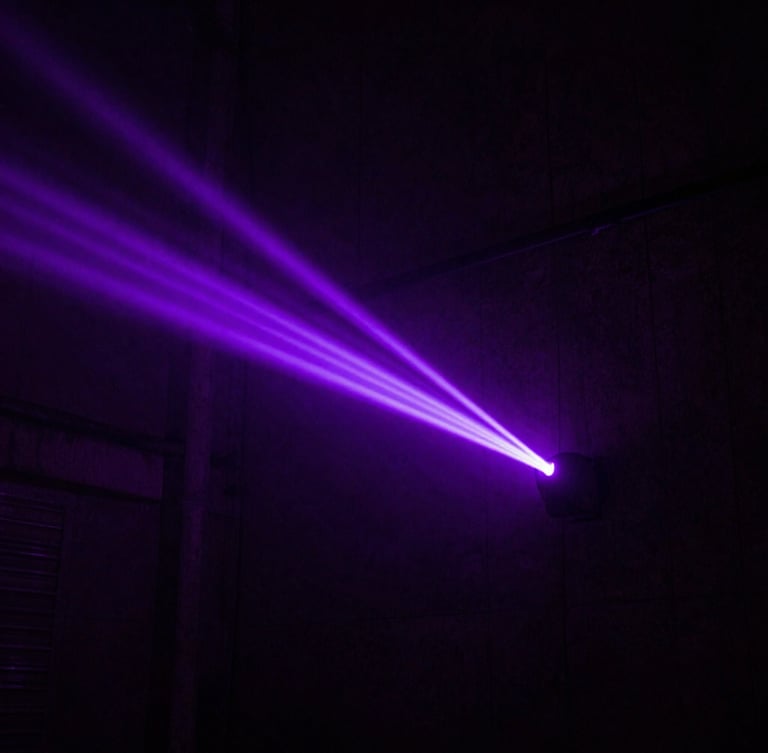 Extreme high-contrast overhead shot of a dark concrete urban alleyway at night, illuminated by a single sharp electric violet neon light beam, heavy atmospheric haze, 35mm photography