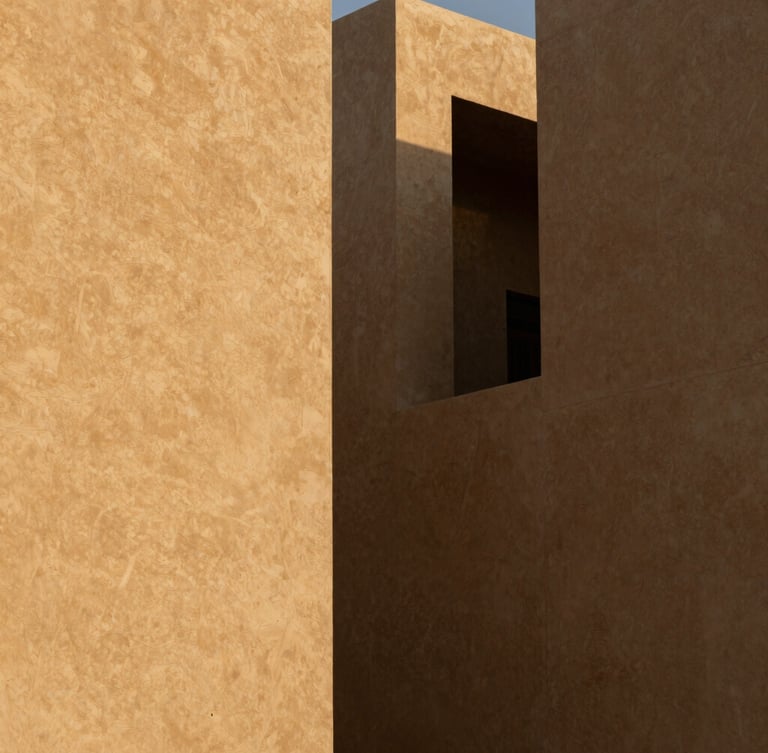 High-contrast architectural shadows on sand-toned concrete facades in Riyadh's financial district, sharp angles, minimalist composition, golden hour light.