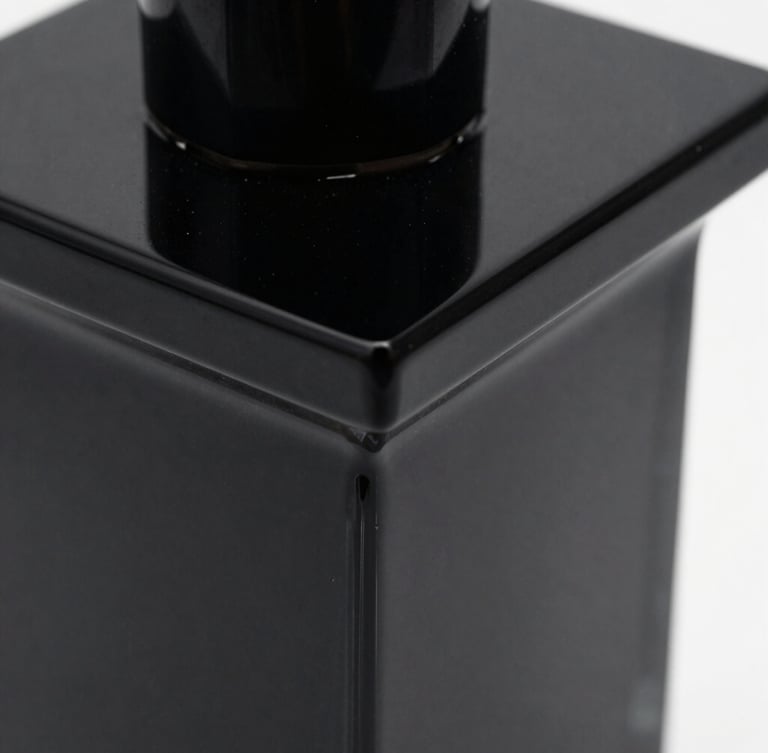 Extreme close-up of a polished black acrylic sculpture with sharp geometric edges, glossy reflections under high-contrast low-key studio light, minimal environment.