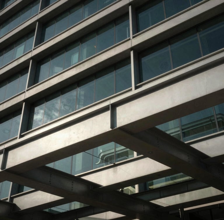 Close-up of structured steel beams and glass facade of a premium corporate headquarters in Muscat, dramatic natural light.