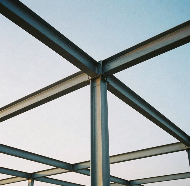 Low-angle heroic shot of structural steel framing against a crisp morning sky, cool steel and slate tones, architectural film photography, sharp focus, 35mm lens.