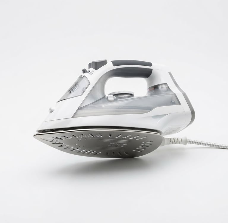 Bright high-key product photography of a heavy-soleplate electric iron on a crisp white background, clean studio lighting, sharp focus, metallic reflections, 50mm lens