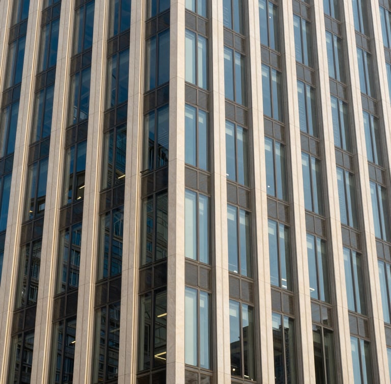 Crisp architectural photography of a modern financial center facade, sharp geometric patterns, bright daylight with cool blue and warm champagne highlights, 35mm lens.